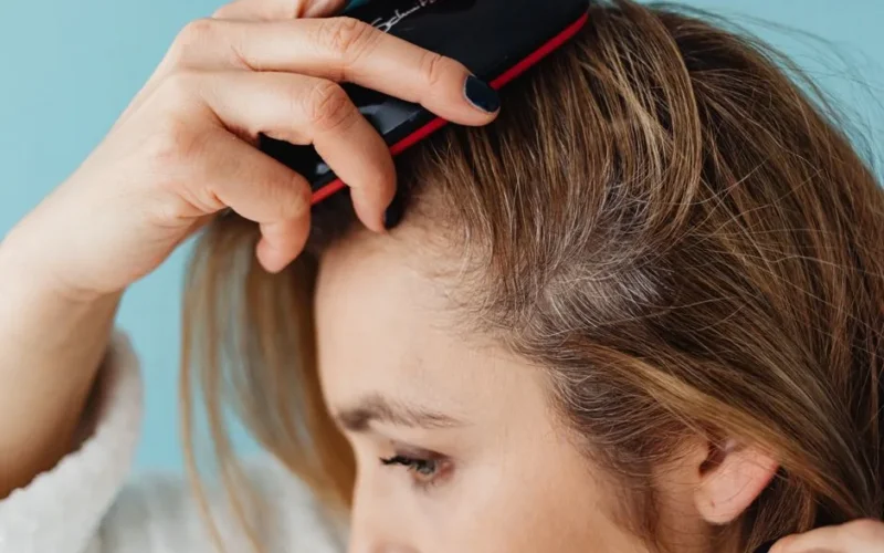 A woman brushing her hair showing hair texture and care.