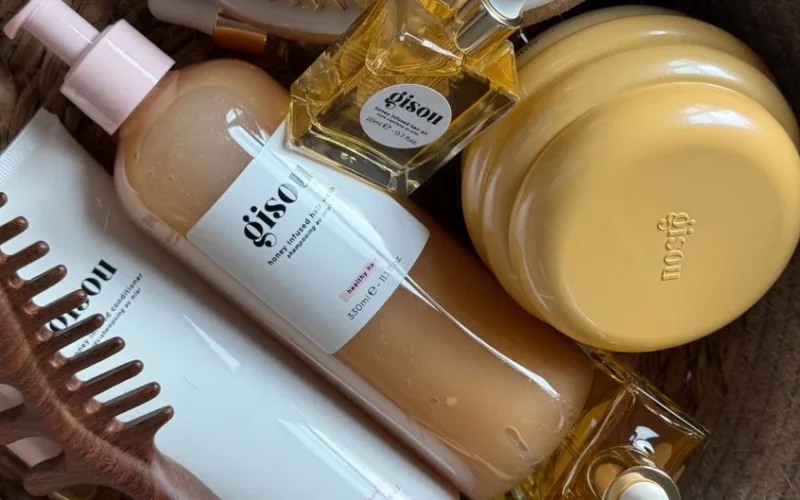 A stylish arrangement of Gisou hair products in a basket with natural aesthetics.